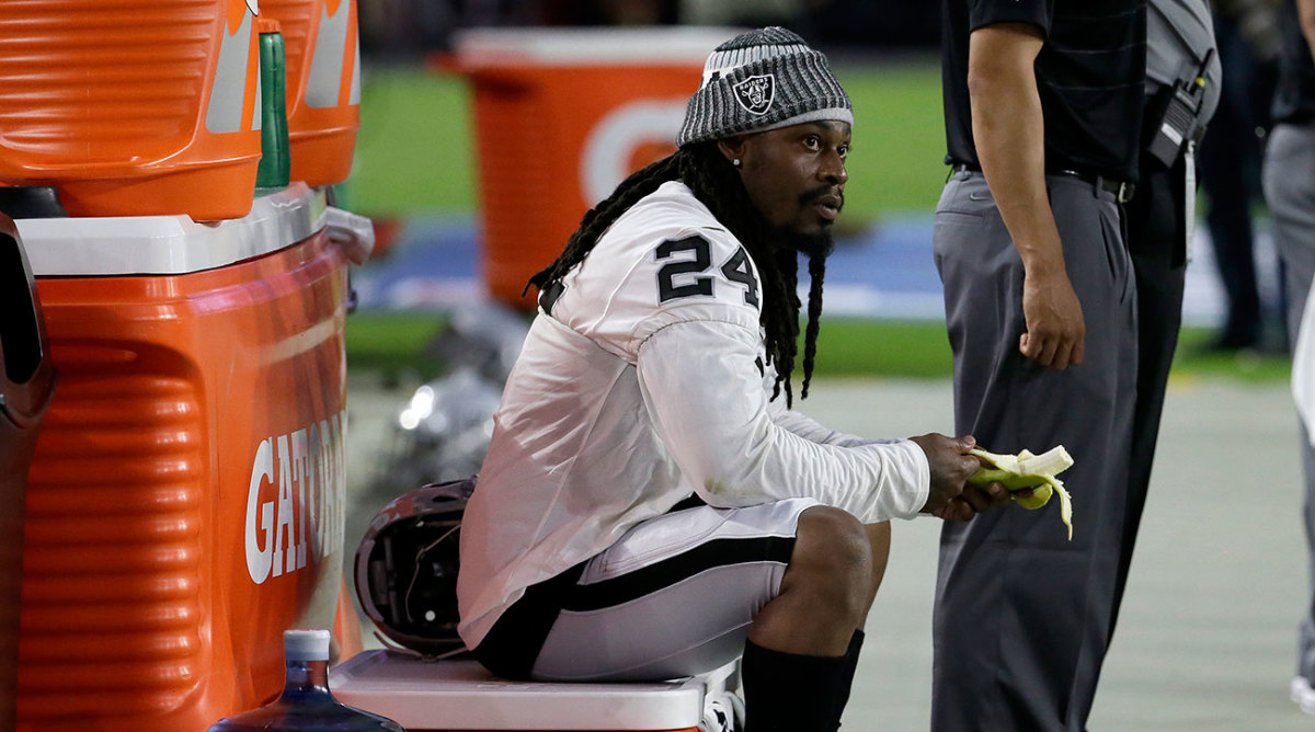 Oakland Raiders running back Marshawn Lynch (24) sits during the national anthem prior to the team's NFL preseason football game against the Arizona Cardinals, Saturday, Aug. 12, 2017, in Glendale, Ariz. (AP Photo/Rick Scuteri)